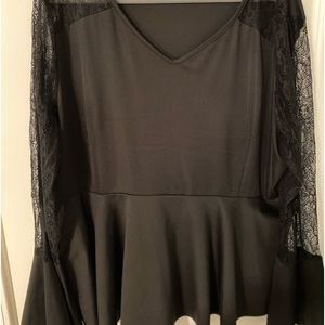 Black blouse with lace bell sleeves.
